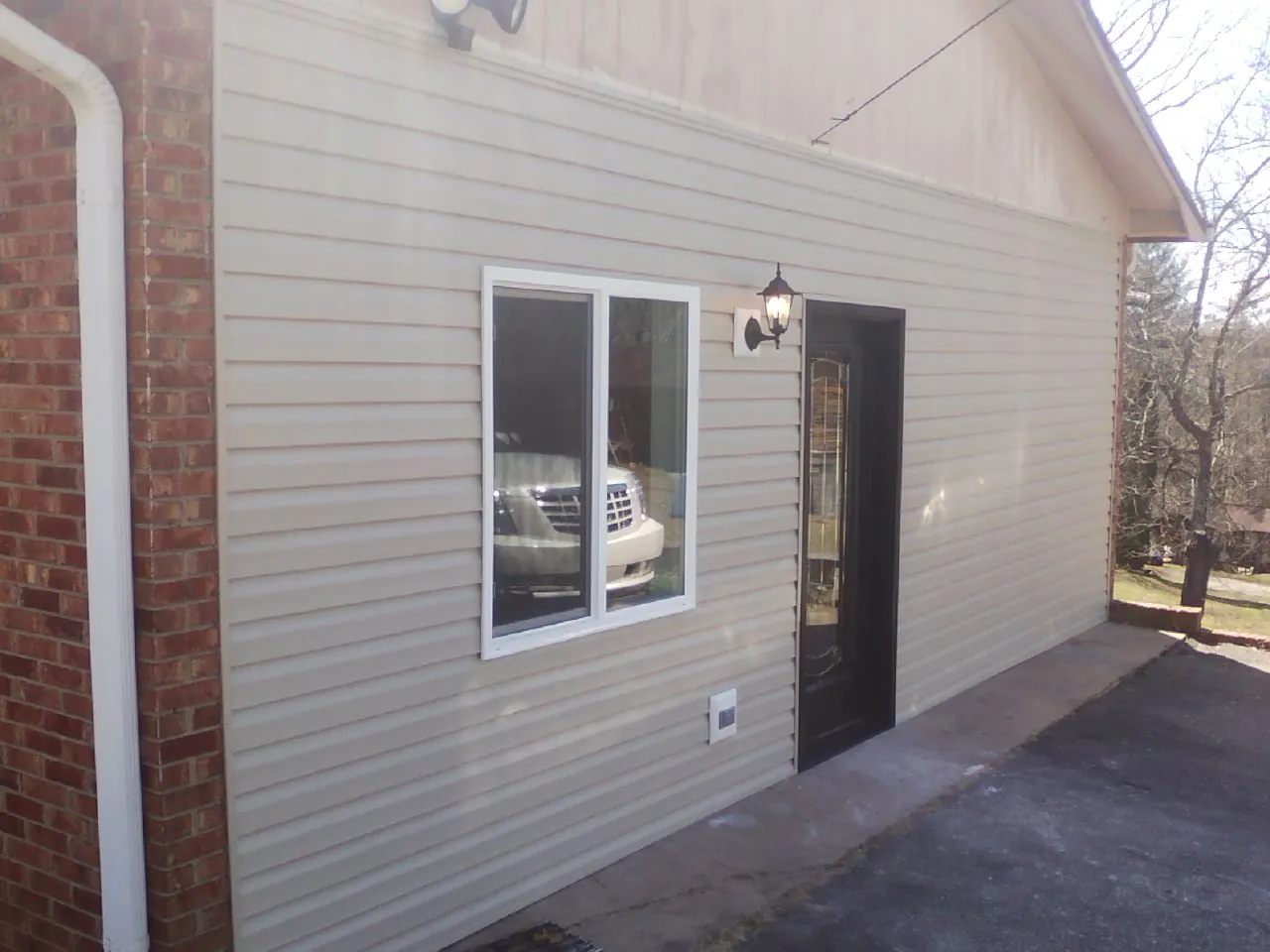 New vinyl siding and entry door on a room addition in Yarmouth