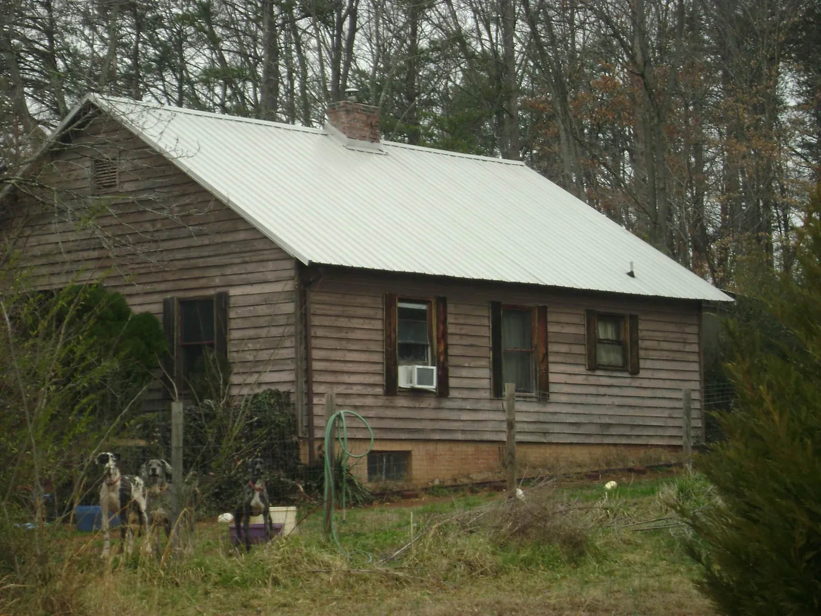 White metal roof on an old wood sided farmhouse, from a Metal Roof Installation job in Yarmouth